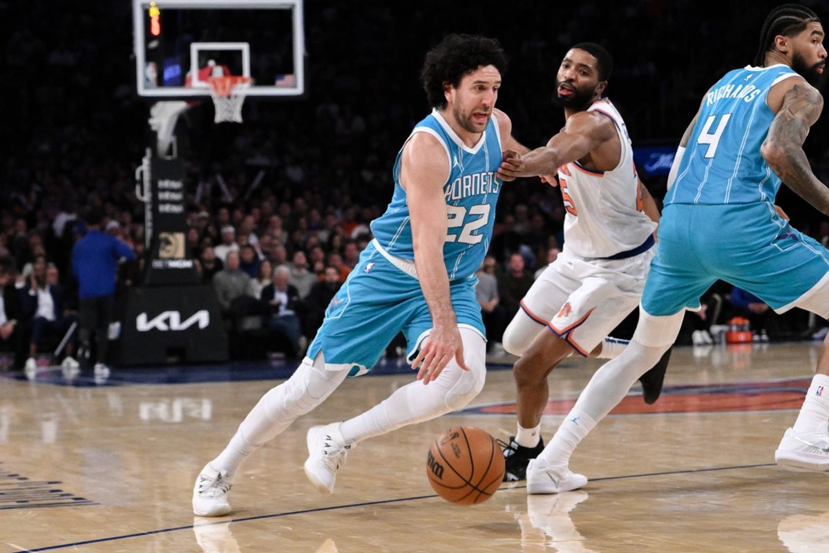 Dec 5, 2024; New York, New York, USA; Charlotte Hornets guard Vasilije Micic (22) drives past New York Knicks forward Mikal Bridges (25) during the first half at Madison Square Garden. Mandatory Credit: John Jones-Imagn Images