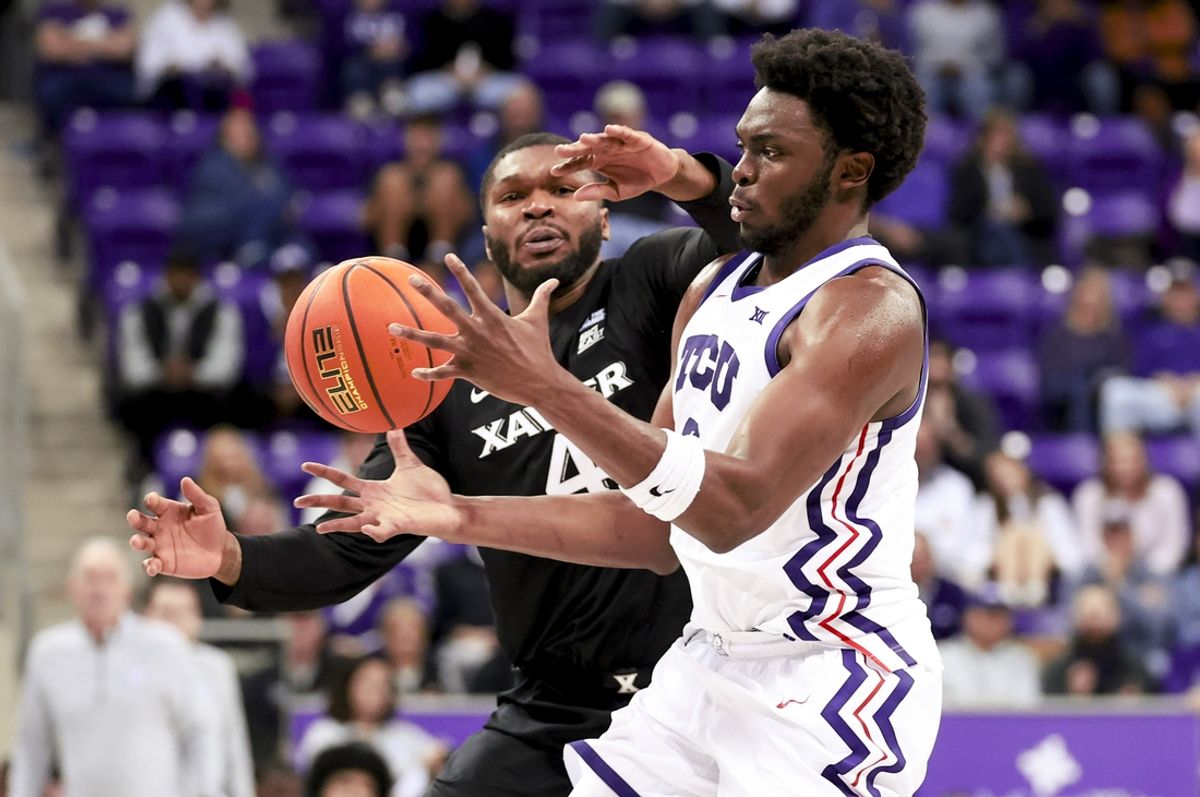 Dec 5, 2024; Fort Worth, Texas, USA;  TCU Horned Frogs center Ernest Udeh Jr. (8) and Xavier Musketeers forward John Hugley IV (4) go for the ball during the second half at Ed and Rae Schollmaier Arena. Mandatory Credit: Kevin Jairaj-Imagn Images