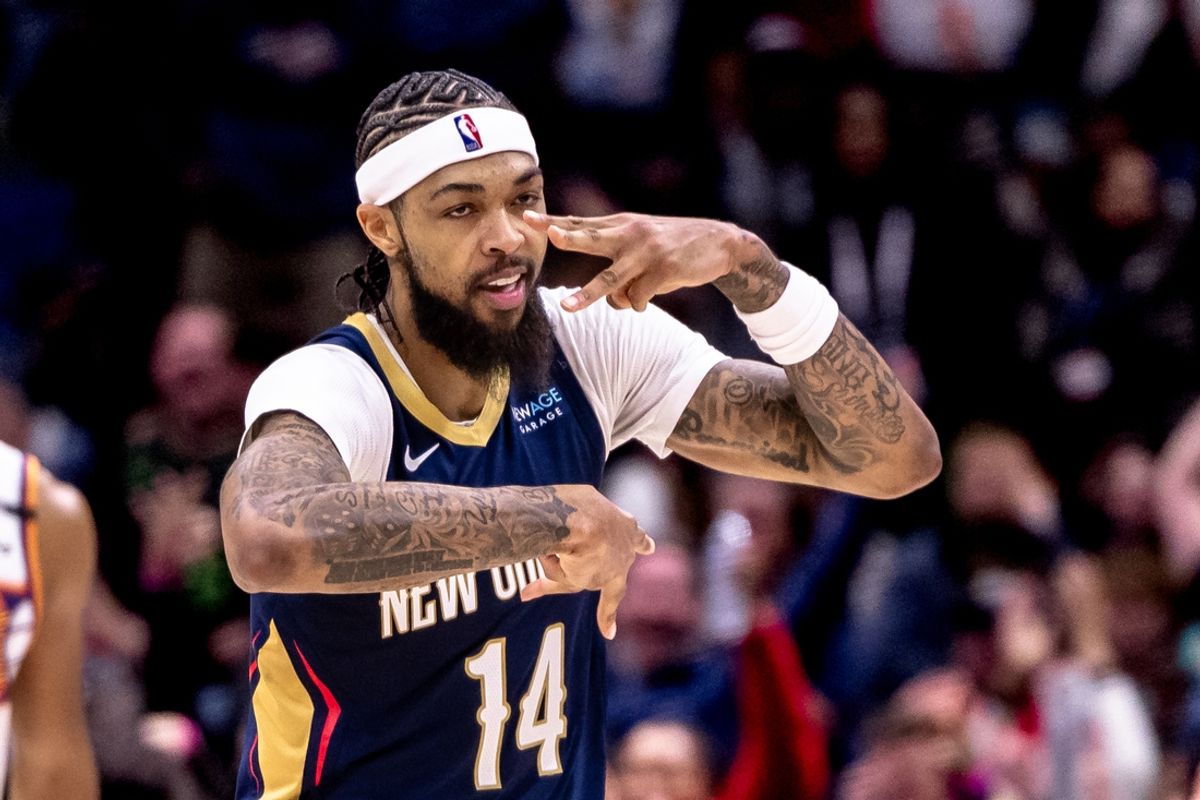 Dec 5, 2024; New Orleans, Louisiana, USA;  New Orleans Pelicans forward Brandon Ingram (14) reacts to making a three point basket against the Phoenix Suns during the first half  at Smoothie King Center. Mandatory Credit: Stephen Lew-Imagn Images