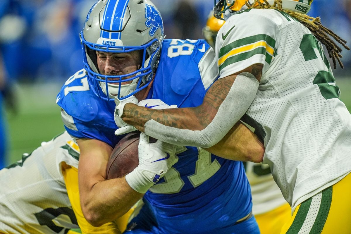 Detroit Lions tight end Sam LaPorta (87) makes a catch before being tacked by Green Bay Packers cornerback Keisean Nixon (25) and safety Xavier McKinney (29) during the Thursday Night Football game at Ford Field in Detroit on Thursday, Dec. 5, 2024.