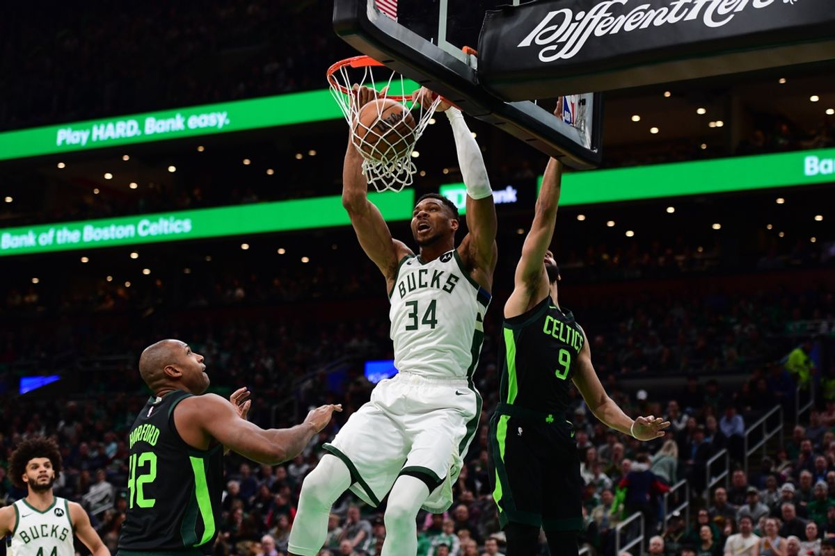 Dec 6, 2024; Boston, Massachusetts, USA;  Milwaukee Bucks forward Giannis Antetokounmpo (34) dunks the ball past Boston Celtics guard Derrick White (9) during the first half at TD Garden. Mandatory Credit: Bob DeChiara-Imagn Images