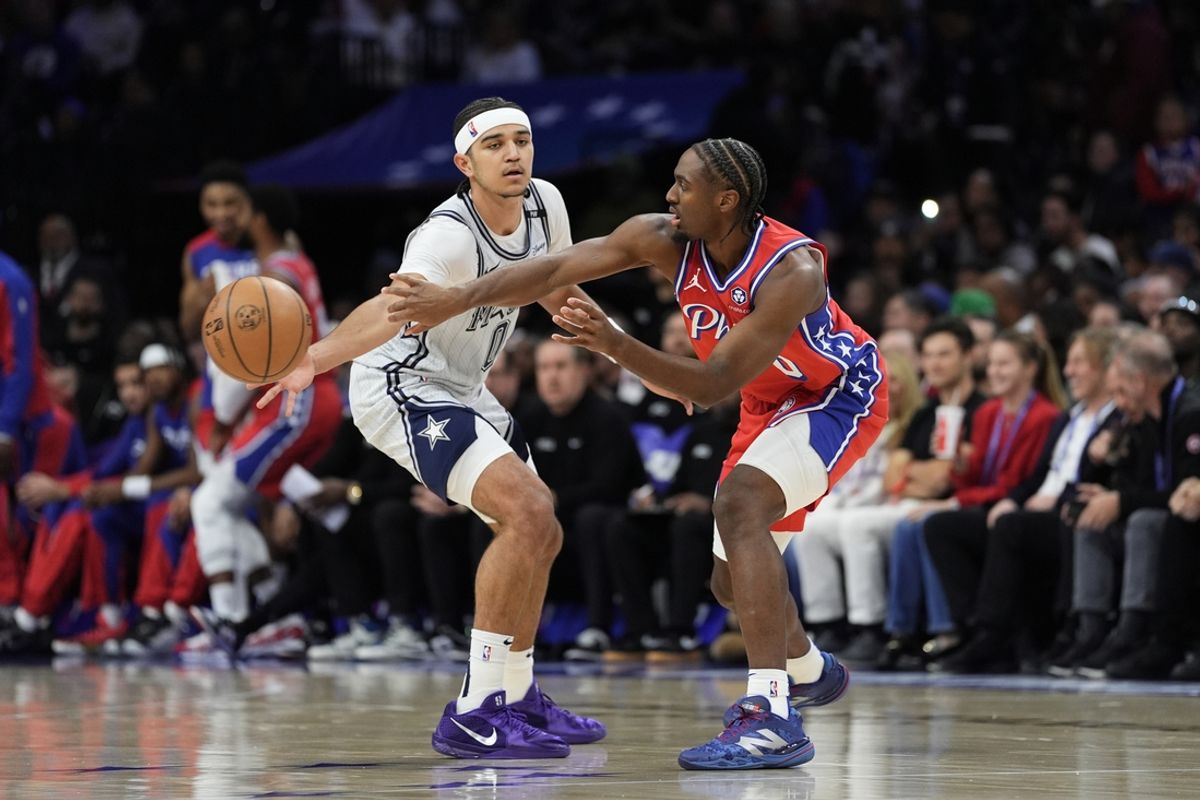 Dec 6, 2024; Philadelphia, Pennsylvania, USA; Philadelphia 76ers guard Tyrese Maxey (0) passes the ball against Orlando Magic guard Anthony Black (0) in the second quarter at Wells Fargo Center. Mandatory Credit: Kyle Ross-Imagn Images