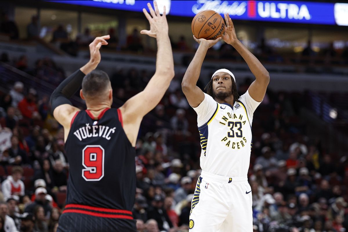 Dec 6, 2024; Chicago, Illinois, USA; Indiana Pacers center Myles Turner (33) shoots against Chicago Bulls center Nikola Vucevic (9) during the first half at United Center. Mandatory Credit: Kamil Krzaczynski-Imagn Images