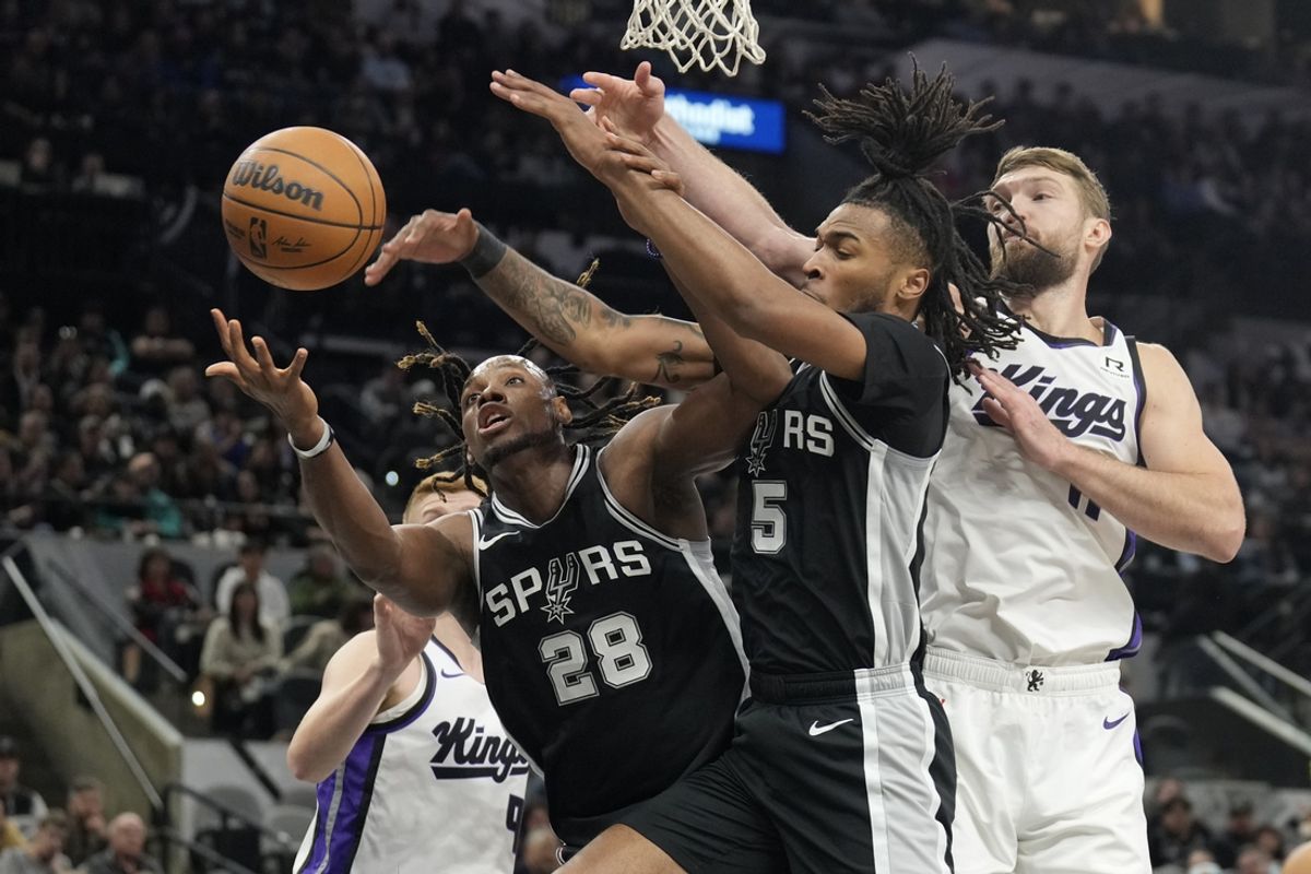 Dec 6, 2024; San Antonio, Texas, USA; San Antonio Spurs center Charles Bassey (28) and guard Stephon Castle (5) battle for the rebound along with Sacramento Kings center Domantas Sabonis (11) during the first half at Frost Bank Center. Mandatory Credit: Scott Wachter-Imagn Images