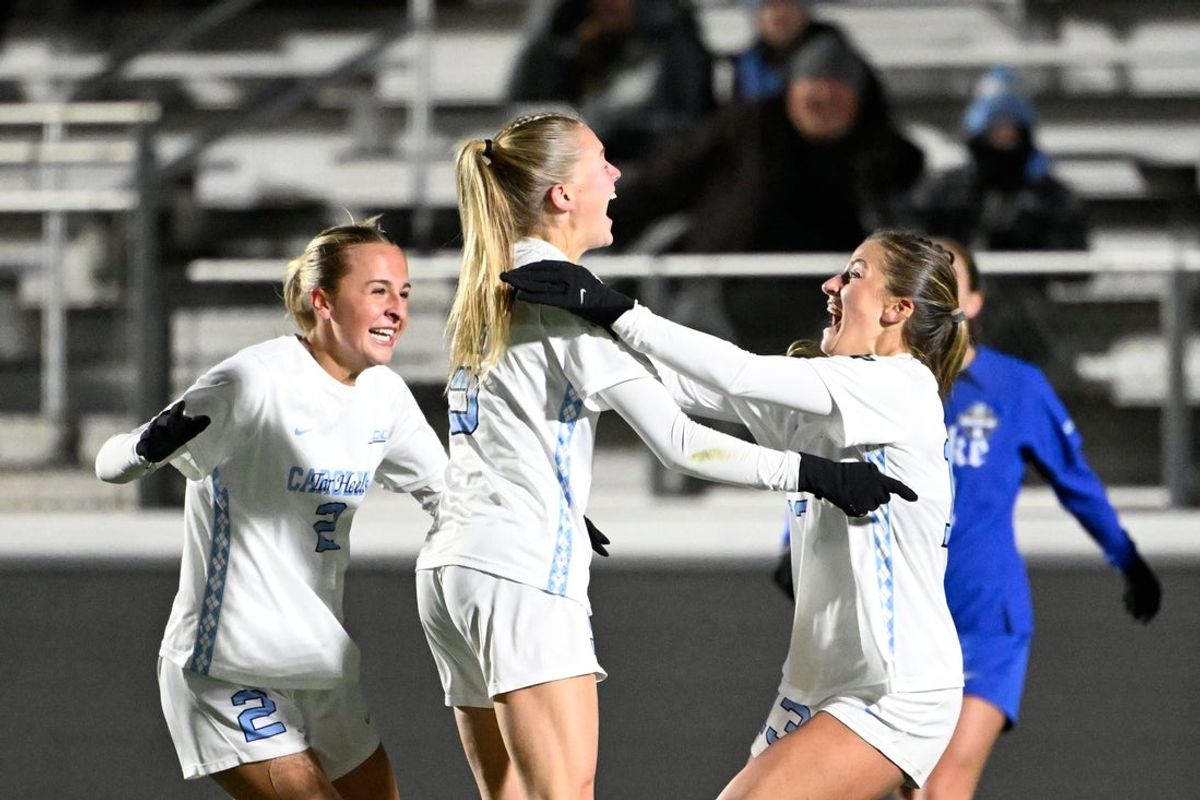 Dec 6, 2024; Cary, NC, USA; North Carolina forward Maddie Dahlien (5) celebrates with midfielder Evelyn Shores (2) and forward Kate Faasse (13) after scoring a goal in the second half at WakeMed Soccer Park. Mandatory Credit: Bob Donnan-Imagn Images