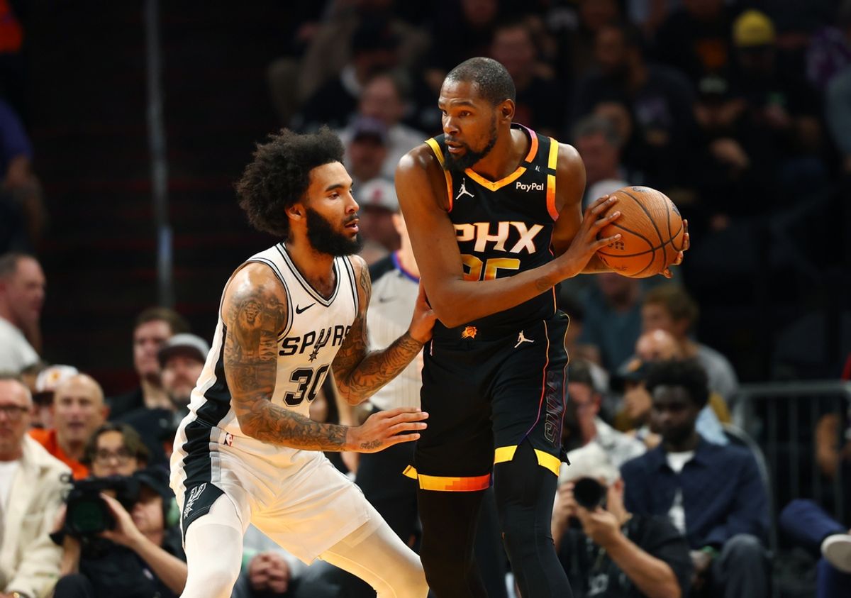 Dec 3, 2024; Phoenix, Arizona, USA; San Antonio Spurs forward Julian Champagnie (30) against Phoenix Suns forward Kevin Durant (35) during an NBA Cup game at Footprint Center. Mandatory Credit: Mark J. Rebilas-Imagn Images