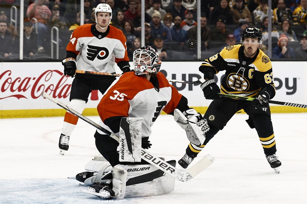 Dec 7, 2024; Boston, Massachusetts, USA; Philadelphia Flyers goaltender Aleksei Kolosov (35) looks around for the puck after making a shoulder save as Boston Bruins left wing Brad Marchand (63) moves in during the first period at TD Garden. Mandatory Credit: Winslow Townson-Imagn Images