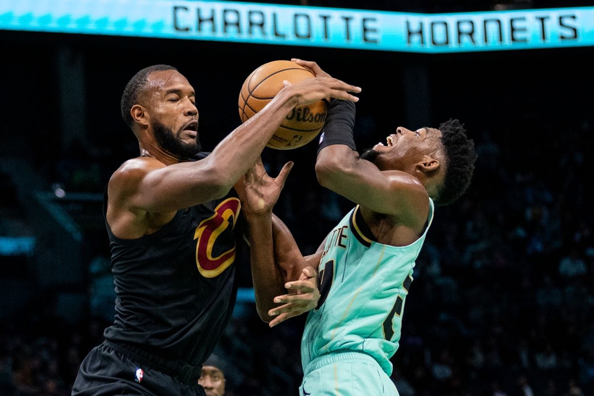 Dec 7, 2024; Charlotte, North Carolina, USA; Charlotte Hornets forward Brandon Miller (24) is fouled by Cleveland Cavaliers forward Evan Mobley (4) during the first quarter at Spectrum Center. Mandatory Credit: Scott Kinser-Imagn Images