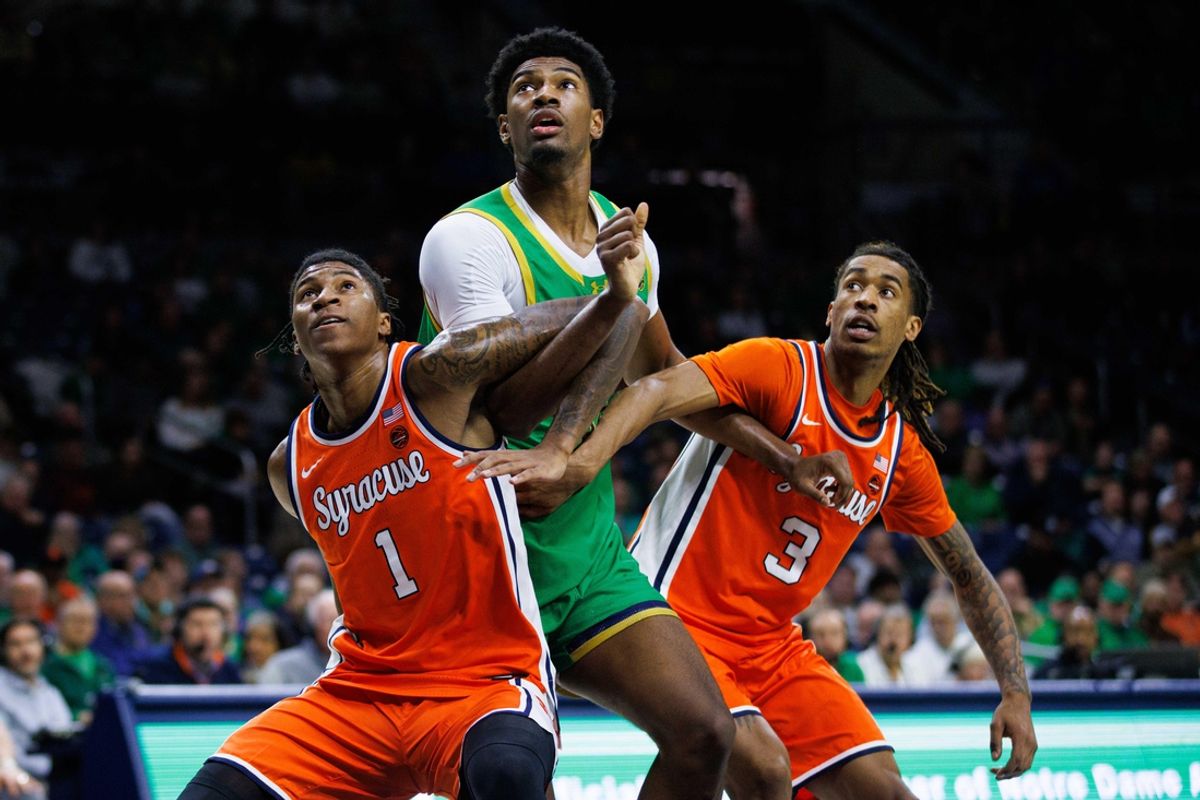 Notre Dame forward Kebba Njie, center, fights for position against Syracuse forward Donnie Freeman (1) and guard Lucas Taylor (3) during a NCAA men's basketball game at Purcell Pavilion on Saturday, Dec. 7, 2024, in South Bend.