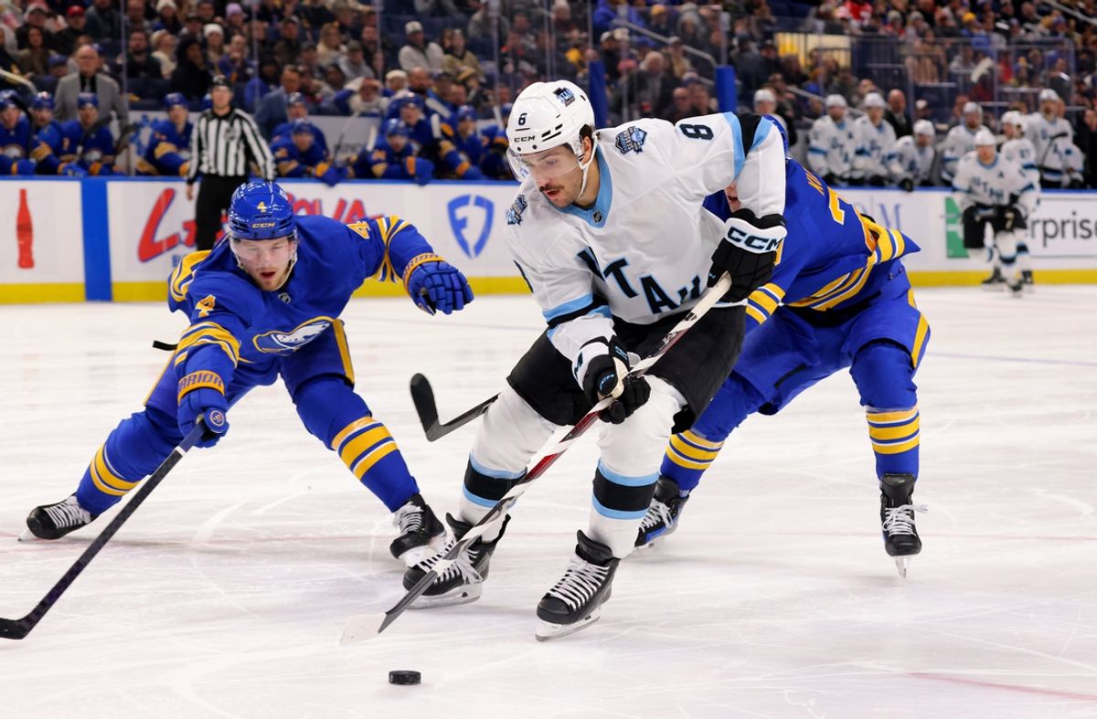 Dec 7, 2024; Buffalo, New York, USA;  Buffalo Sabres defenseman Bowen Byram (4) looks to block a pass by Utah Hockey Club center Nick Schmaltz (8) during the third period at KeyBank Center. Mandatory Credit: Timothy T. Ludwig-Imagn Images