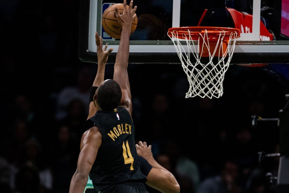 Dec 7, 2024; Charlotte, North Carolina, USA; Cleveland Cavaliers forward Evan Mobley (4) block a shot from Charlotte Hornets forward Taj Gibson (67) during the fourth quarter at Spectrum Center. Mandatory Credit: Scott Kinser-Imagn Images