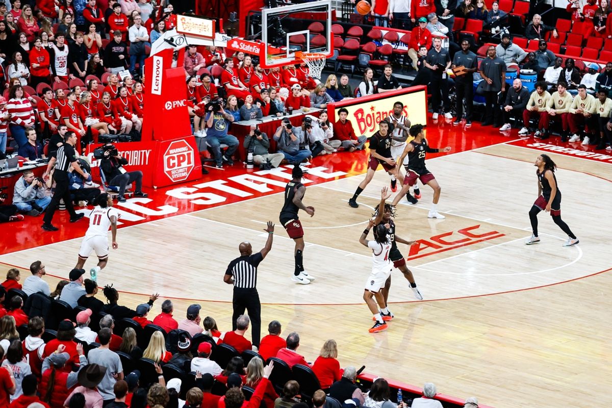 Dec 7, 2024; Raleigh, North Carolina, USA; North Carolina State Wolfpack guard Breon Pass (4) shoots a three point shot during the first half of the game against Florida State Seminoles at Lenovo Center. Mandatory Credit: Jaylynn Nash-Imagn Images