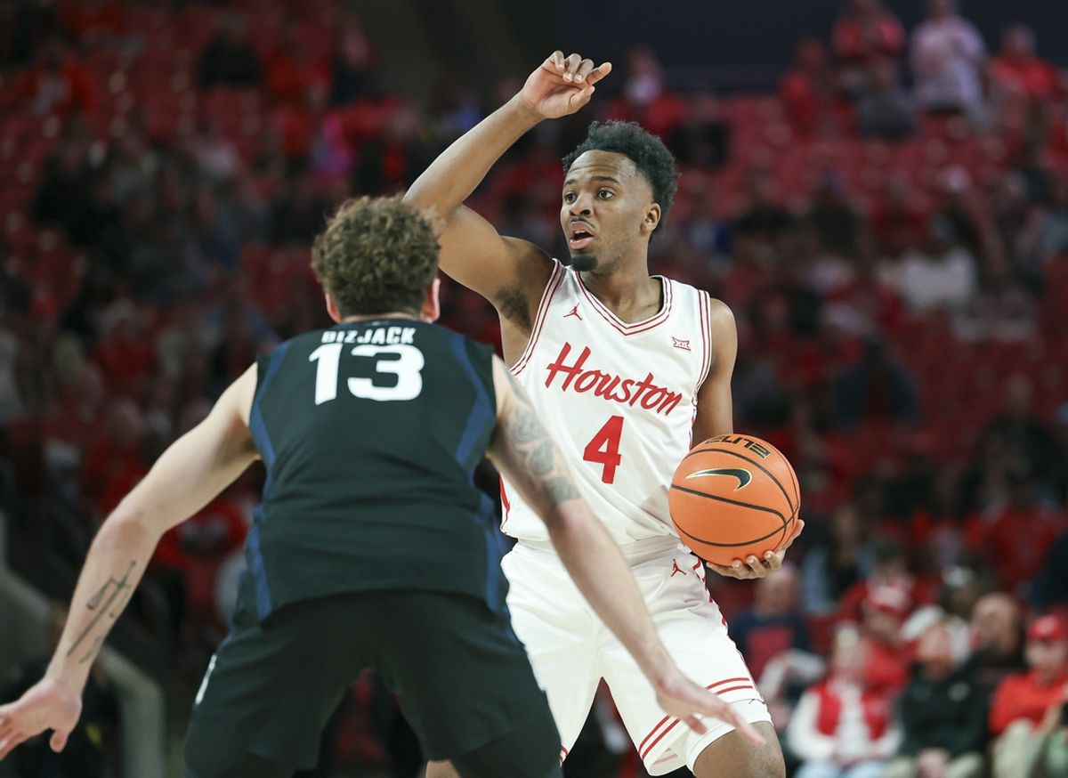 Dec 7, 2024; Houston, Texas, USA; Houston Cougars guard L.J. Cryer (4) controls the ball as Butler Bulldogs guard Finley Bizjack (13) defends during the first half at Fertitta Center. Mandatory Credit: Troy Taormina-Imagn Images
