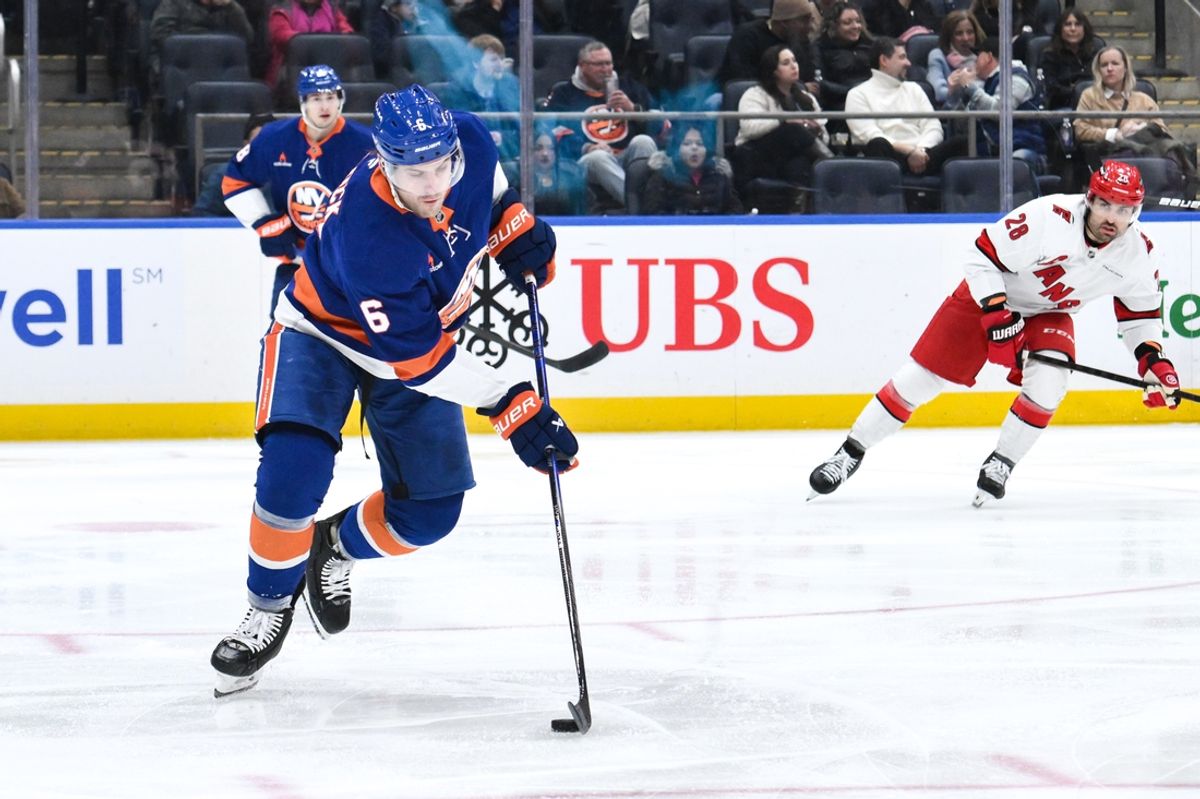 Dec 7, 2024; Elmont, New York, USA; New York Islanders defenseman Ryan Pulock (6) skates with the puck against the Carolina Hurricanes during the second period at UBS Arena. Mandatory Credit: John Jones-Imagn Images