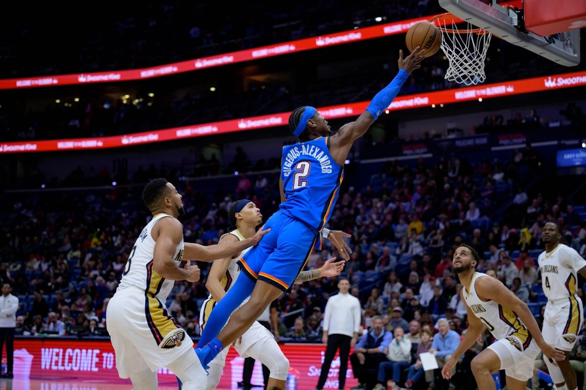 Dec 7, 2024; New Orleans, Louisiana, USA; Oklahoma City Thunder guard Shai Gilgeous-Alexander (2) shoots against New Orleans Pelicans guard CJ McCollum (3) during the first half at Smoothie King Center. Mandatory Credit: Matthew Hinton-Imagn Images