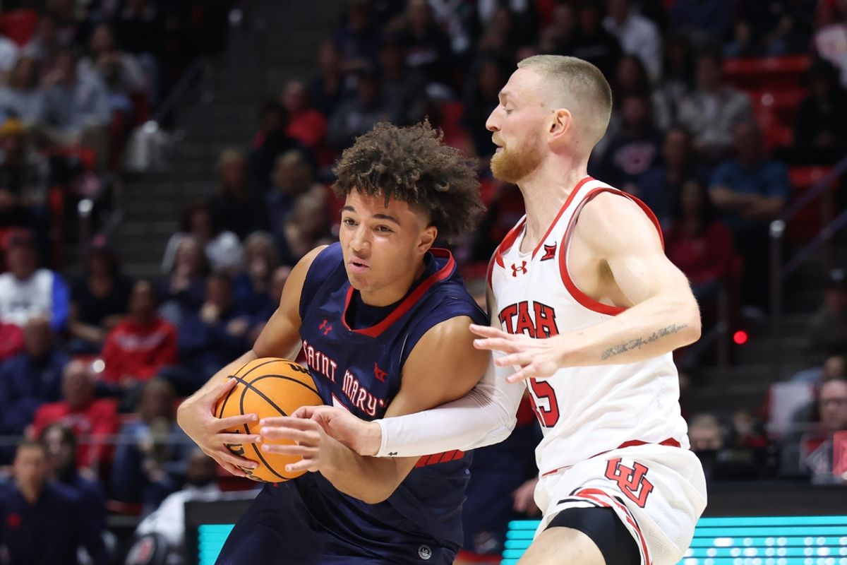 Dec 7, 2024; Salt Lake City, Utah, USA; St. Mary's Gaels guard Jordan Ross (2) drives against Utah Utes guard Mason Madsen (45) during the first half at Jon M. Huntsman Center. Mandatory Credit: Rob Gray-Imagn Images
