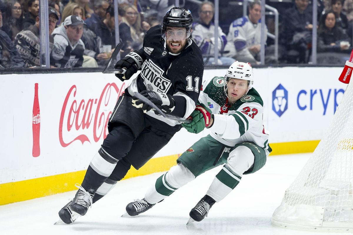 Dec 7, 2024; Los Angeles, California, USA; Los Angeles Kings center Anze Kopitar (11) skates against Minnesota Wild center Marco Rossi (33) during the first period at Crypto.com Arena. Mandatory Credit: Ryan Sun-Imagn Images