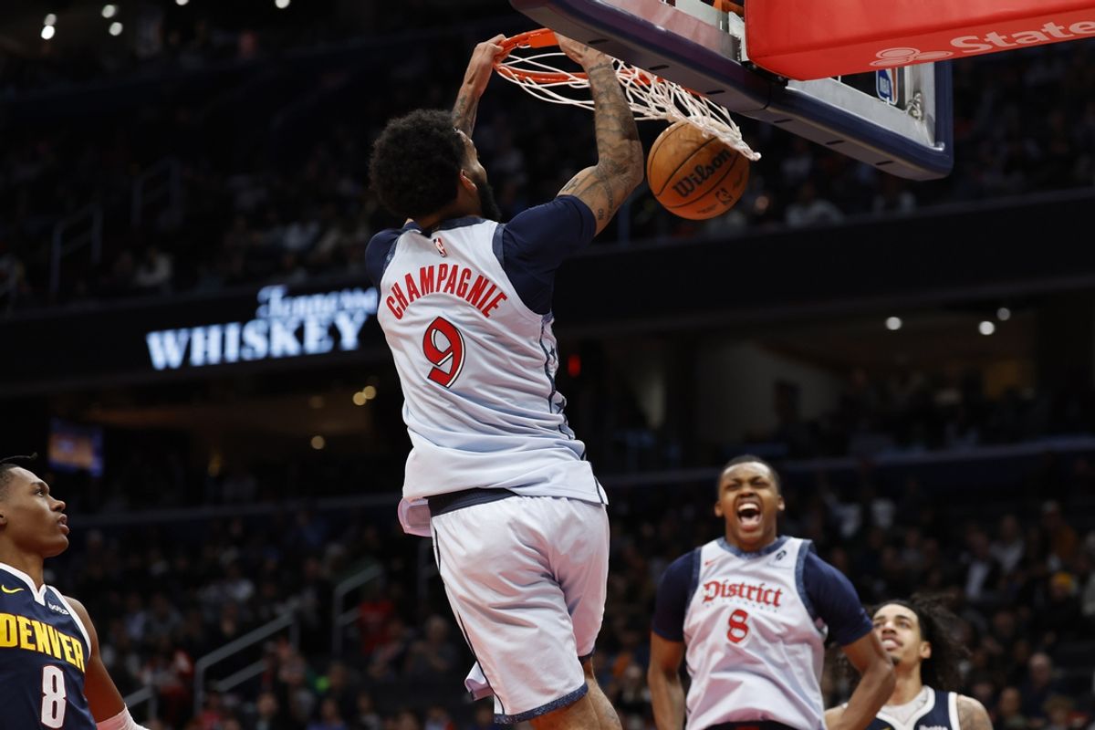 Dec 7, 2024; Washington, District of Columbia, USA; Washington Wizards forward Justin Champagnie (9) dunks the ball as Denver Nuggets forward Peyton Watson (8) and Wizards guard Bub Carrington (8) look on in the fourth quarter at Capital One Arena. Mandatory Credit: Geoff Burke-Imagn Images