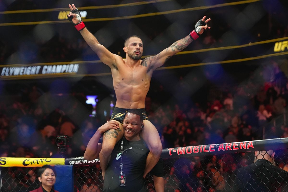 Dec 7, 2024; Las Vegas, Nevada, UNITED STATES; Alexandre Pantoja (red gloves) reacts after defeating Kai Asakura (blues gloves) at T-Mobile Arena. Mandatory Credit: Stephen R. Sylvanie-Imagn Images