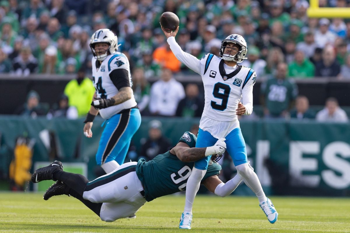 Dec 8, 2024; Philadelphia, Pennsylvania, USA;  Carolina Panthers quarterback Bryce Young (9) passes the ball while being hit by Philadelphia Eagles defensive tackle Jalen Carter (98) during the first quarter at Lincoln Financial Field. Mandatory Credit: Bill Streicher-Imagn Images