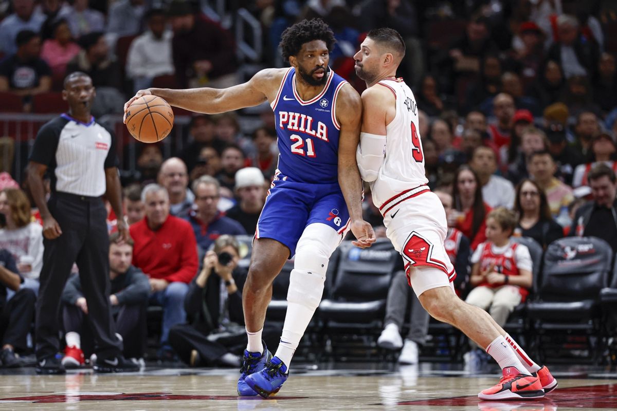 Dec 8, 2024; Chicago, Illinois, USA; Chicago Bulls center Nikola Vucevic (9) defends against Philadelphia 76ers center Joel Embiid (21) during the first half at United Center. Mandatory Credit: Kamil Krzaczynski-Imagn Images