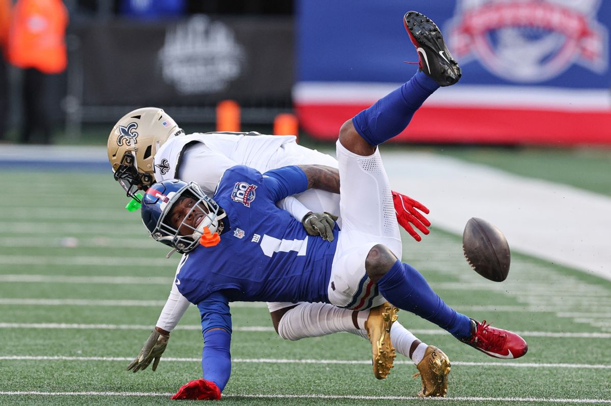 Dec 8, 2024; East Rutherford, New Jersey, USA; New Orleans Saints cornerback Kool-Aid McKinstry (14) breaks up a pass intended for New York Giants wide receiver Malik Nabers (1) during the first half at MetLife Stadium. Mandatory Credit: Vincent Carchietta-Imagn Images