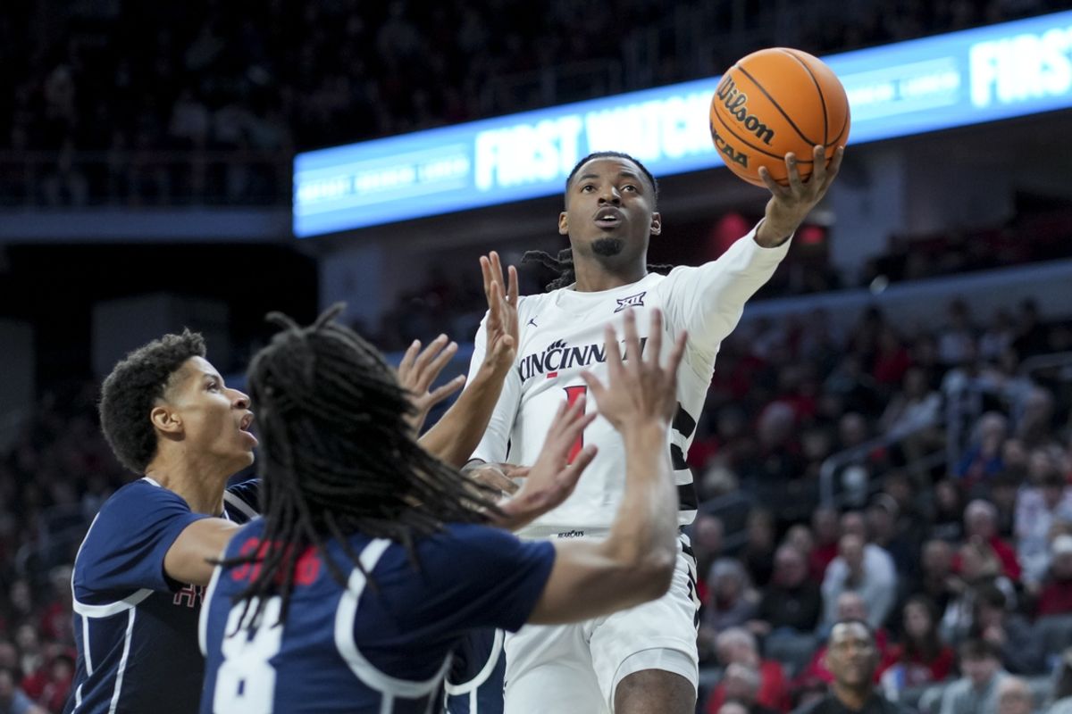 Dec 8, 2024; Cincinnati, Ohio, USA; Howard Bison guard Jaren Johnson (3) defends as Cincinnati Bearcats guard Day Day Thomas (1) drives to the basket in the first half at Fifth Third Arena. Mandatory Credit: Aaron Doster-Imagn Images