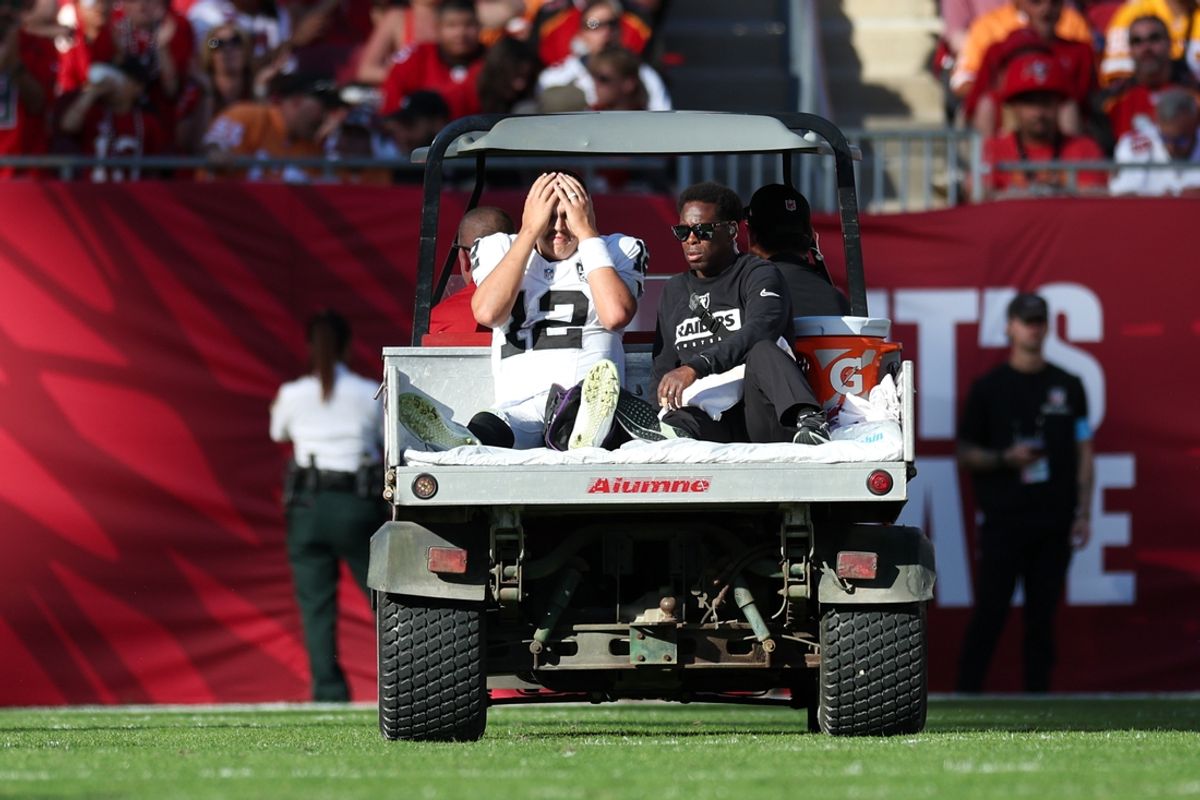 Dec 8, 2024; Tampa, Florida, USA; Las Vegas Raiders quarterback Aidan O'Connell (12) is carted off the field against the Tampa Bay Buccaneers in the third quarter at Raymond James Stadium. Mandatory Credit: Nathan Ray Seebeck-Imagn Images