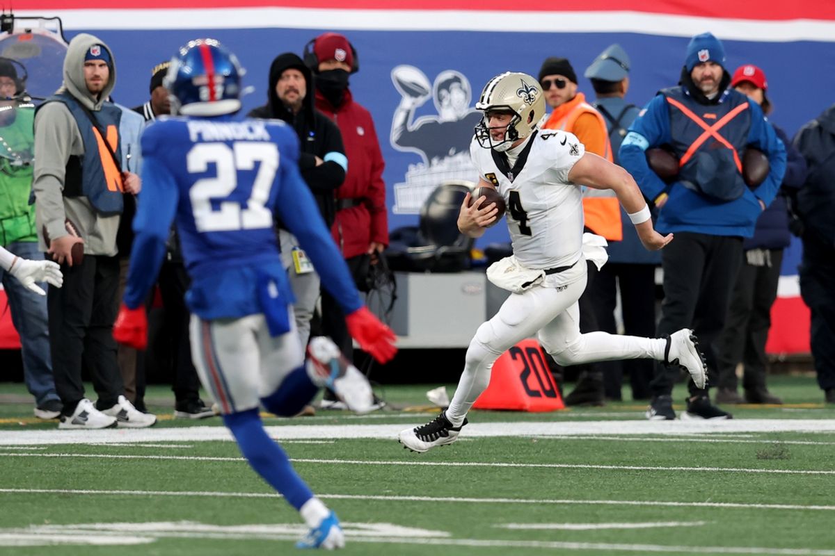 Dec 8, 2024; East Rutherford, New Jersey, USA; New Orleans Saints quarterback Derek Carr (4) runs with the ball against the New York Giants during the fourth quarter at MetLife Stadium. Mandatory Credit: Brad Penner-Imagn Images