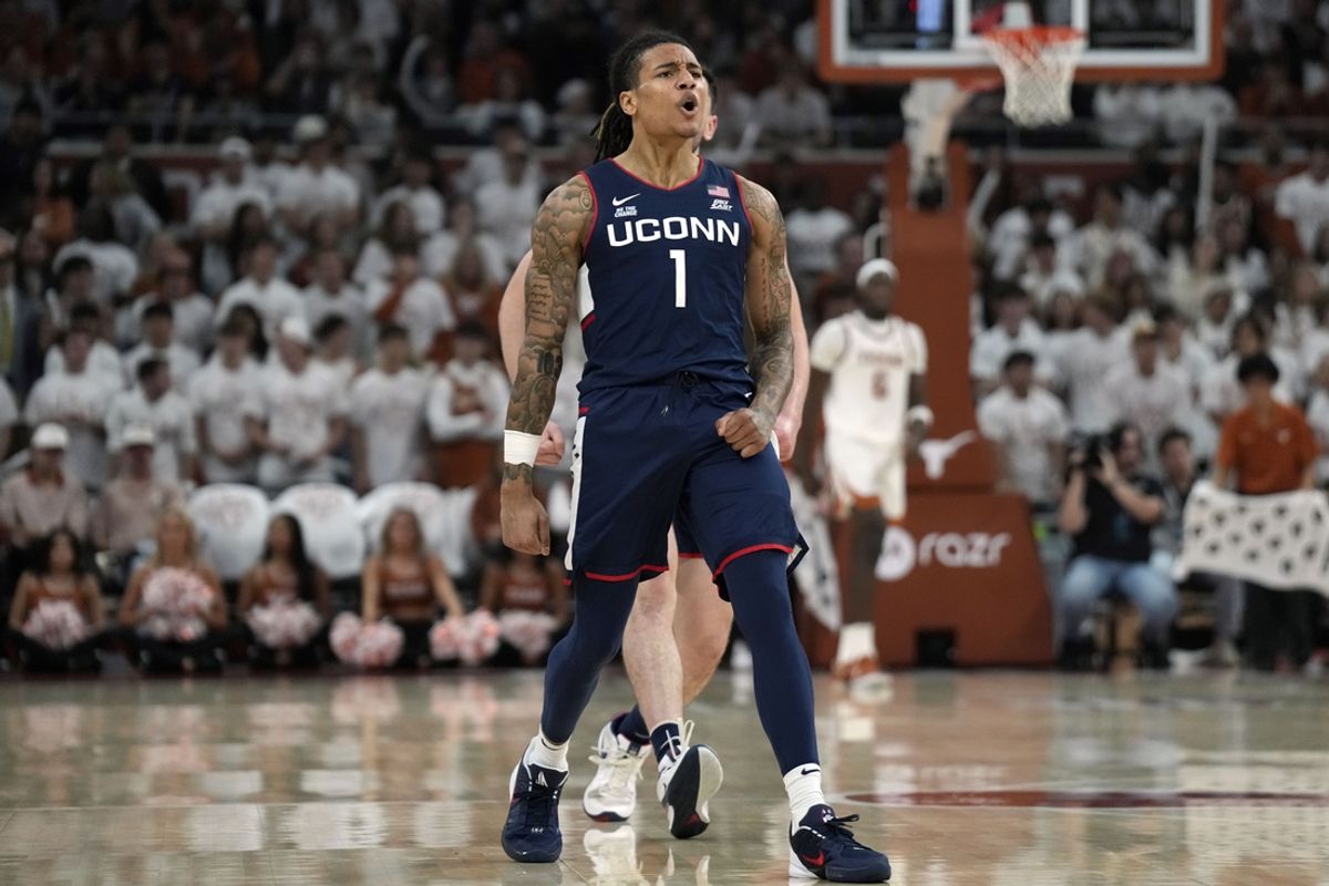 Dec 8, 2024; Austin, Texas, USA; Connecticut Huskies guard Solo Ball (1) reacts after scoring a three point basket during the first half against the Texas Longhorns at Moody Center. Mandatory Credit: Scott Wachter-Imagn Images