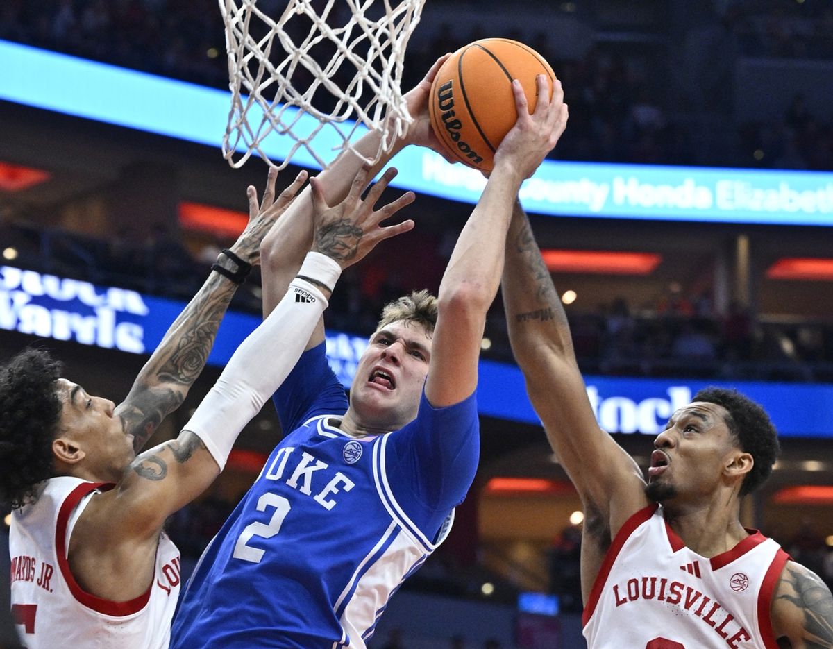 Dec 8, 2024; Louisville, Kentucky, USA;  Duke Blue Devils guard Cooper Flagg (2) shoots against Louisville Cardinals guard Terrence Edwards Jr. (5) and forward James Scott (0) during the first half at KFC Yum! Center. Mandatory Credit: Jamie Rhodes-Imagn Images
