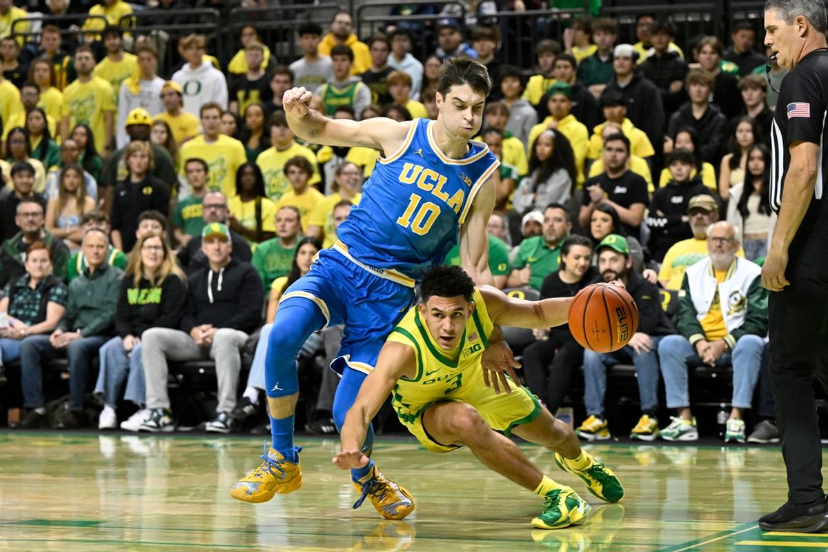 Dec 8, 2024; Eugene, Oregon, USA; Oregon Ducks guard Jackson Shelstad (3) drives thru contact with UCLA Bruins guard Lazar Stefanovic (10) during the first half at Matthew Knight Arena. Mandatory Credit: Craig Strobeck-Imagn Images