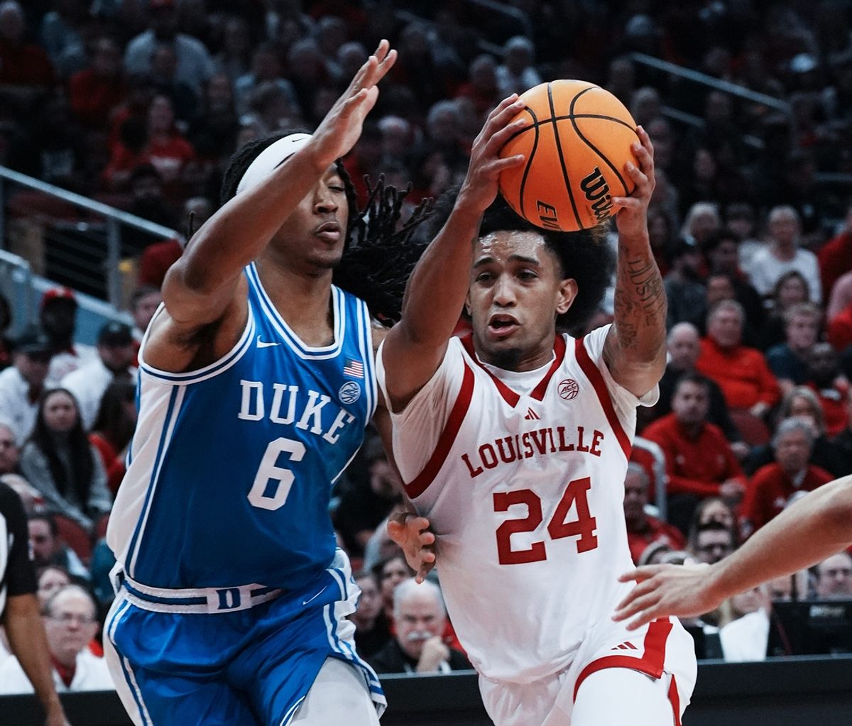 Louisville's Chucky Hepburn (24) drives against Duke' s Maliq Brown (6) during their game at the KFC Yum! Center in Louisville, Ky. on Dec. 8, 2024.