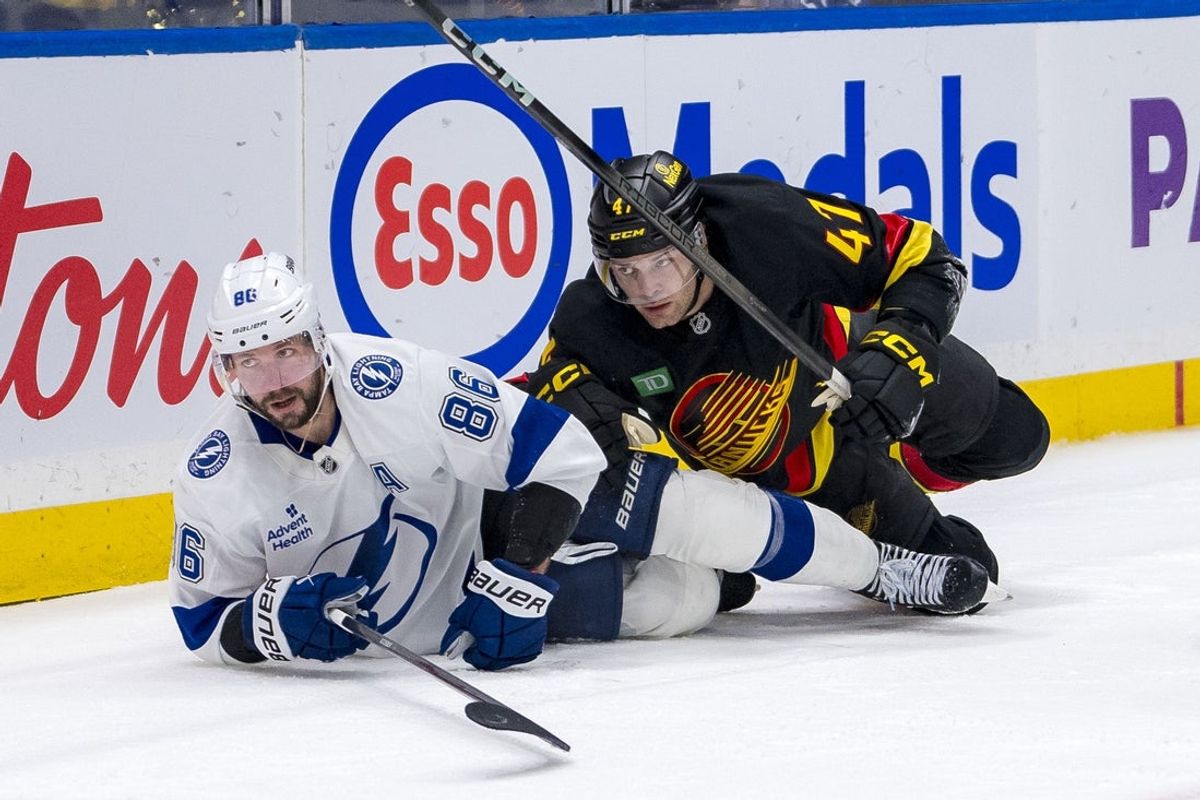 Dec 8, 2024; Vancouver, British Columbia, CAN; Vancouver Canucks defenseman Noah Juulsen (47) checks Tampa Bay Lightning forward Nikita Kucherov (86) during the third period at Rogers Arena. Mandatory Credit: Bob Frid-Imagn Images