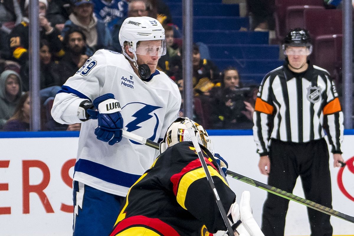 Dec 8, 2024; Vancouver, British Columbia, CAN; Vancouver Canucks goalie Kevin Lankinen (32) watches as the rebound hits Tampa Bay Lightning forward Jake Guentzel (59) during the third period at Rogers Arena. Mandatory Credit: Bob Frid-Imagn Images