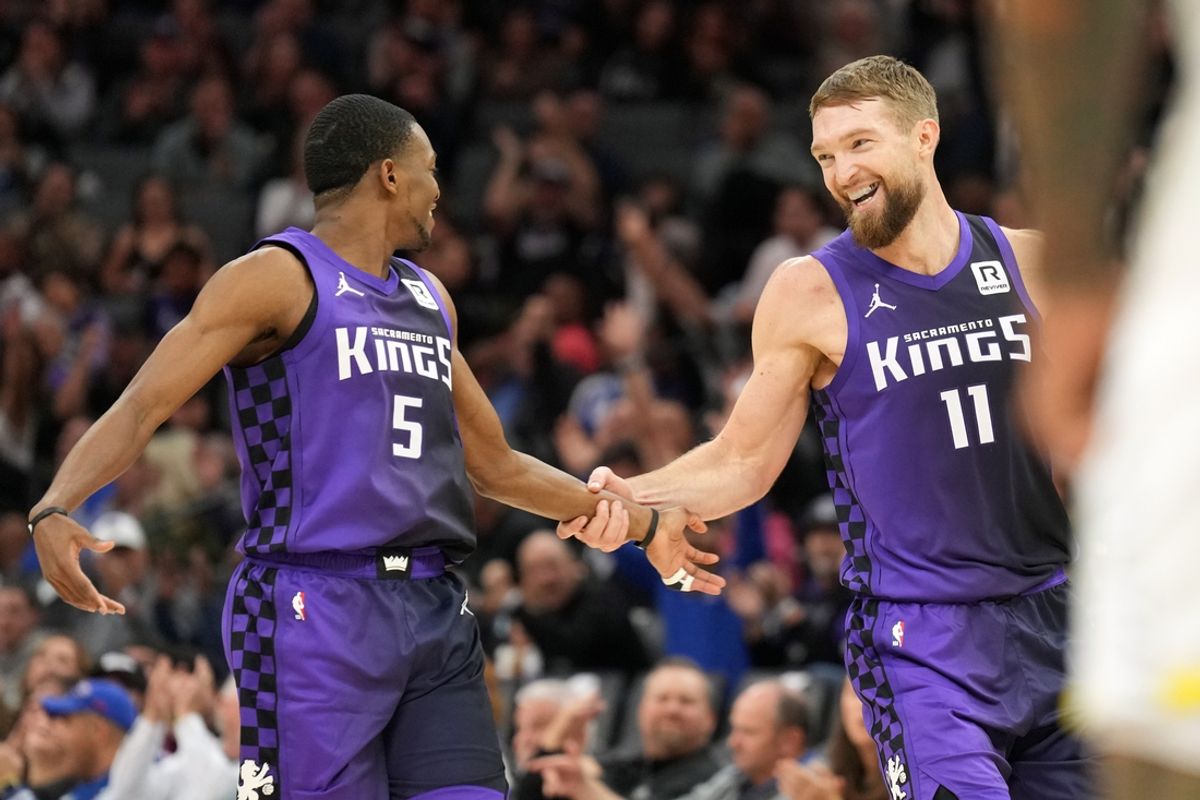 Dec 8, 2024; Sacramento, California, USA; Sacramento Kings forward Domantas Sabonis (11) is congratulated by guard De'Aaron Fox (5) after making a three point basket against the Utah Jazz during the second quarter at Golden 1 Center. Mandatory Credit: Darren Yamashita-Imagn Images