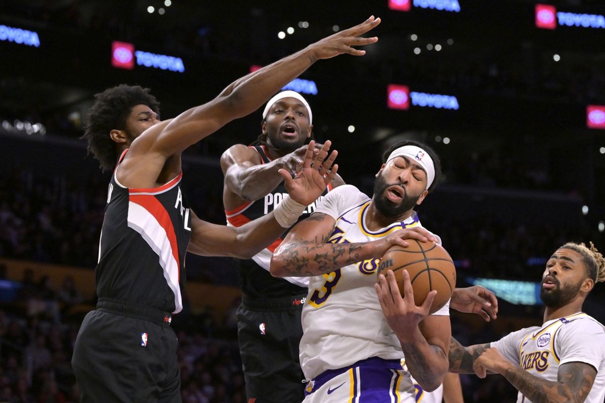 Dec 8, 2024; Los Angeles, California, USA;  Portland Trail Blazers guard Scoot Henderson (00) and forward Jerami Grant (9) defend a rebound by Los Angeles Lakers forward Anthony Davis (3) in the first half at Crypto.com Arena. Mandatory Credit: Jayne Kamin-Oncea-Imagn Images