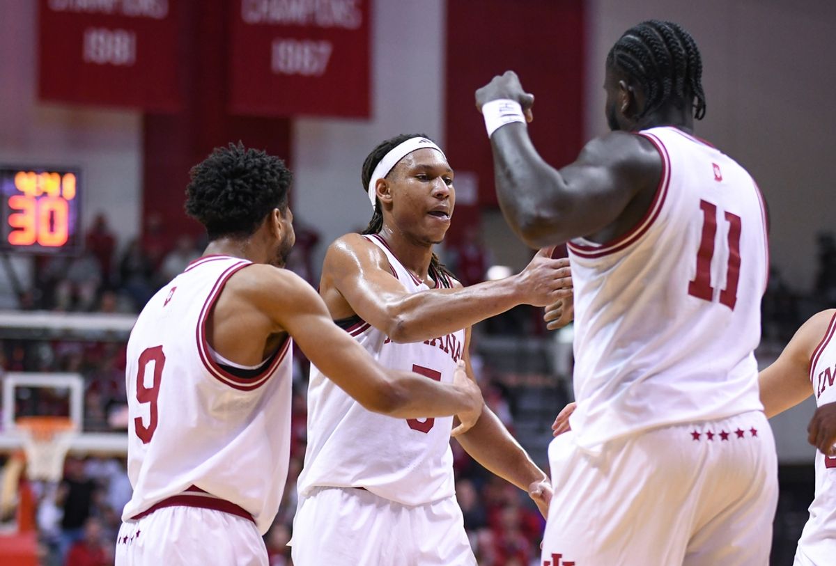 Dec 9, 2024; Bloomington, Indiana, USA; Indiana Hoosiers guard Kanaan Carlyle (9), forward Malik Reneau (5) and  center Oumar Ballo (11) celebrate after a play during the first half against the Minnesota Golden Gophers at Simon Skjodt Assembly Hall. Mandatory Credit: Robert Goddin-Imagn Images