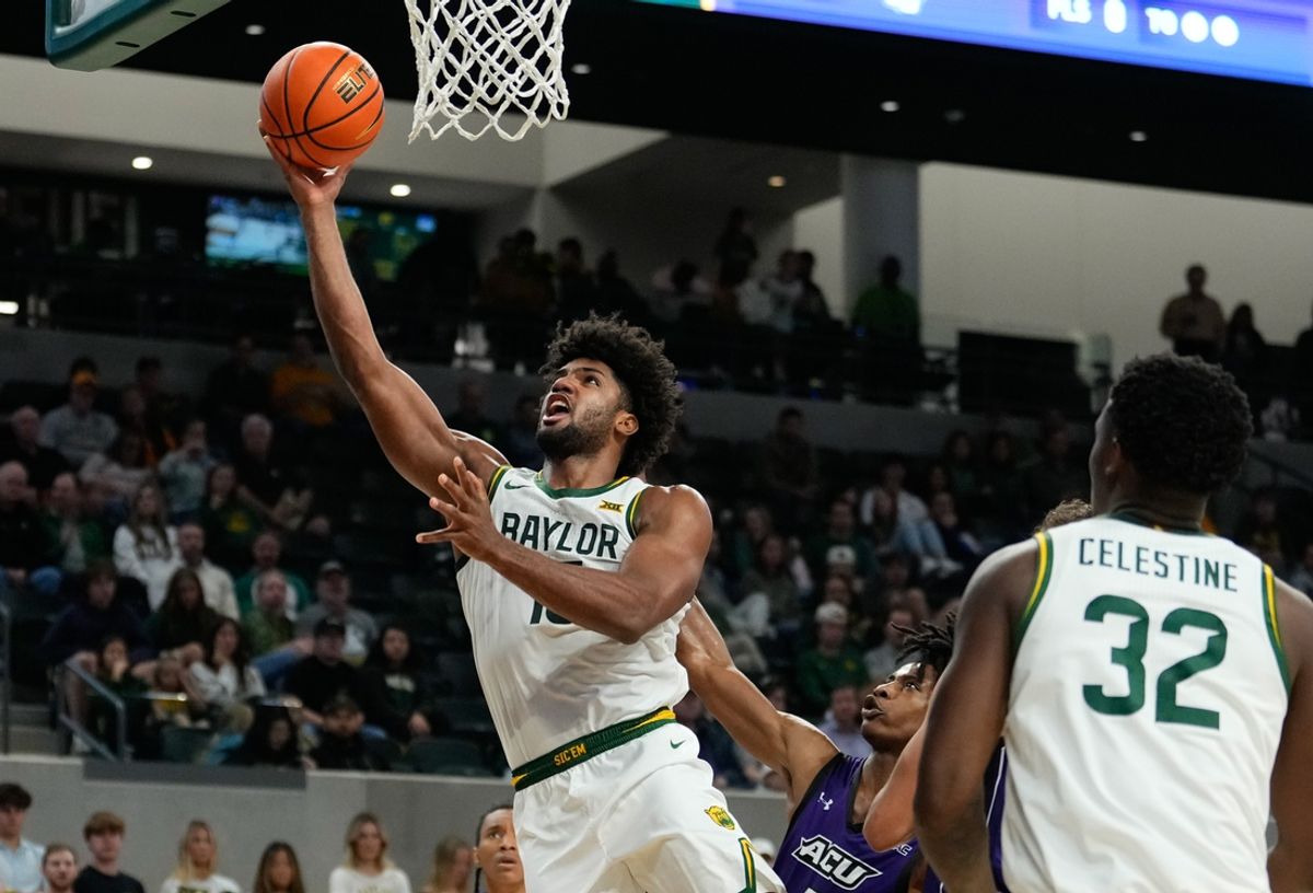 Dec 9, 2024; Waco, Texas, USA;  Baylor Bears forward Norchad Omier (15) scores against Abilene Christian Wildcats guard Quion Williams (5) during the second half at Paul and Alejandra Foster Pavilion. Mandatory Credit: Chris Jones-Imagn Images