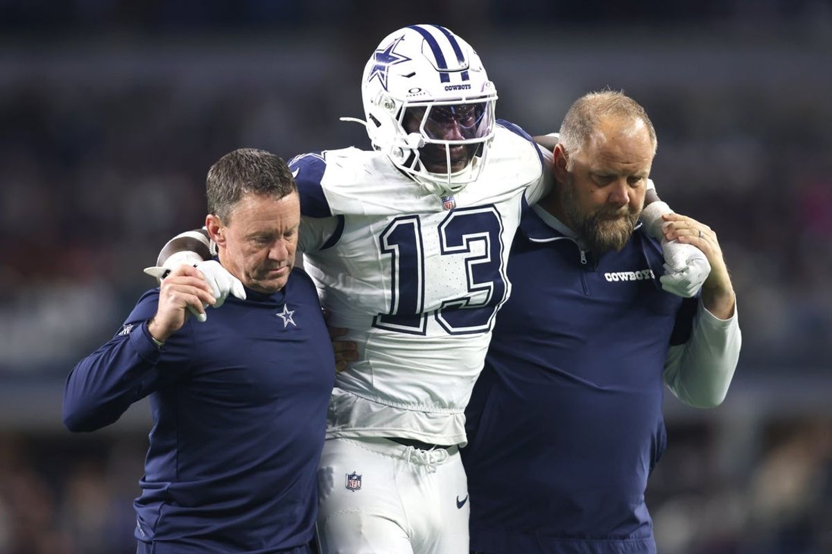 Dec 9, 2024; Arlington, Texas, USA; Dallas Cowboys linebacker DeMarvion Overshown (13) is helped off the field after an injury in the second half against the Cincinnati Bengals at AT&T Stadium. Mandatory Credit: Tim Heitman-Imagn Images