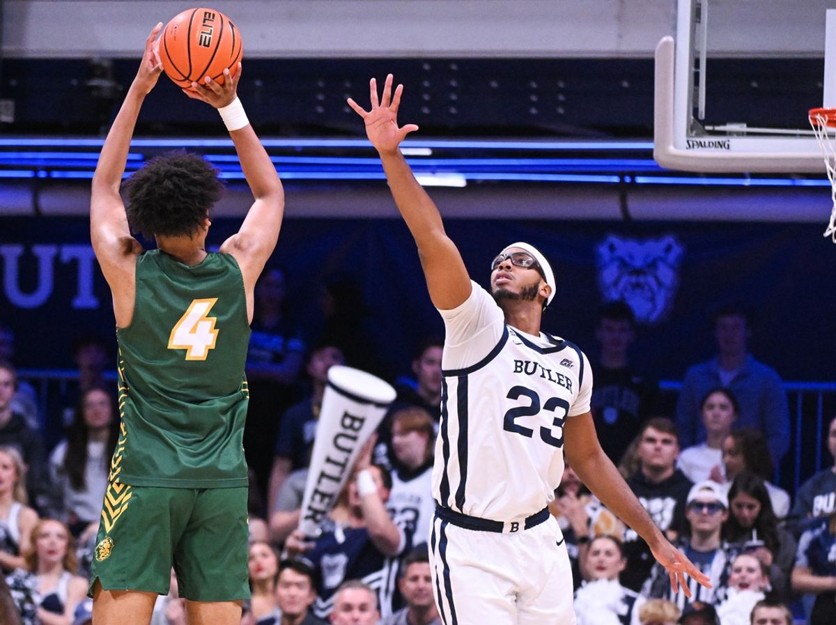 Dec 10, 2024; Indianapolis, Indiana, USA; North Dakota State Bison forward Jacksen Moni (4) scores over Butler Bulldogs center Andre Screen (23) during the first half at Hinkle Fieldhouse. Mandatory Credit: Robert Goddin-Imagn Images