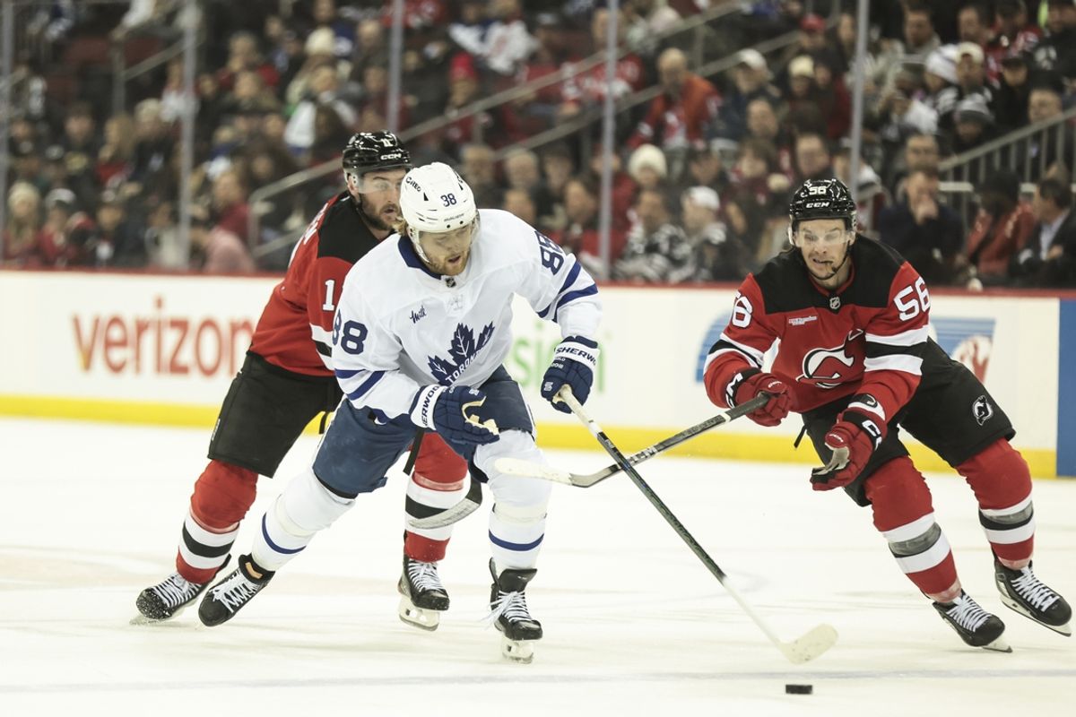 Dec 10, 2024; Newark, New Jersey, USA;   Toronto Maple Leafs right wing William Nylander (88) fights for the puck against New Jersey Devils left wing Erik Haula (56) during the first period at Prudential Center. Mandatory Credit: Luther Schlaifer-Imagn Images