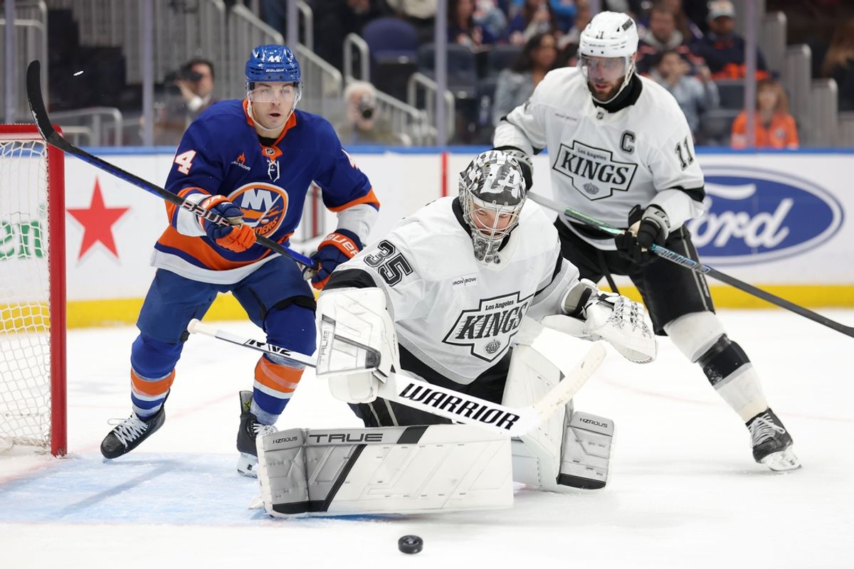 Dec 10, 2024; Elmont, New York, USA; Los Angeles Kings goaltender Darcy Kuemper (35) plays the puck against New York Islanders center Jean-Gabriel Pageau (44) in front of Kings center Anze Kopitar (11) during the second period at UBS Arena. Mandatory Credit: Brad Penner-Imagn Images