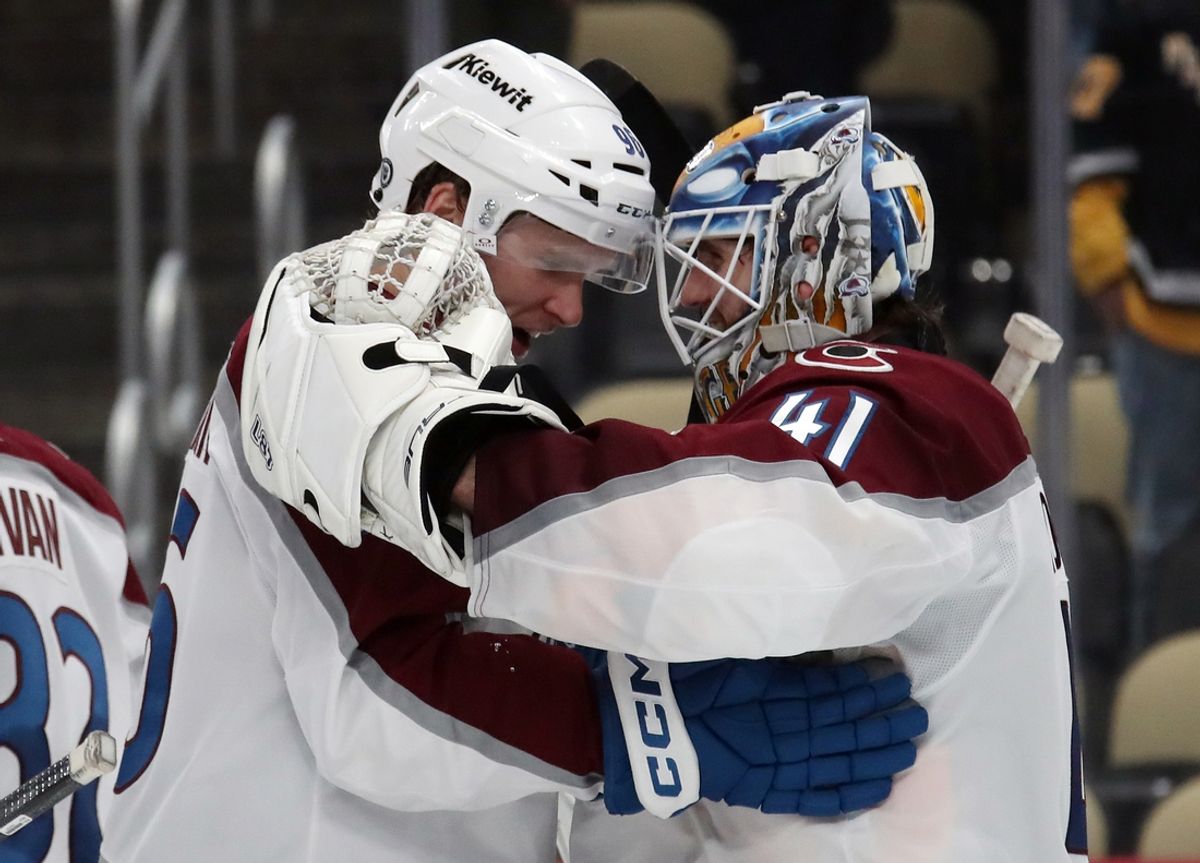 Dec 10, 2024; Pittsburgh, Pennsylvania, USA;  Colorado Avalanche right wing Mikko Rantanen (left) and goaltender Scott Wedgewood (41) celebrate after defeating the Pittsburgh Penguins at PPG Paints Arena. Mandatory Credit: Charles LeClaire-Imagn Images