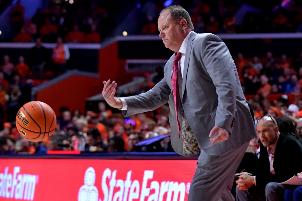 Dec 10, 2024; Champaign, Illinois, USA;  Wisconsin Badgers head coach Greg Gard throws the ball to a referee during the second half against the Illinois Fighting Illini at State Farm Center. Mandatory Credit: Ron Johnson-Imagn Images