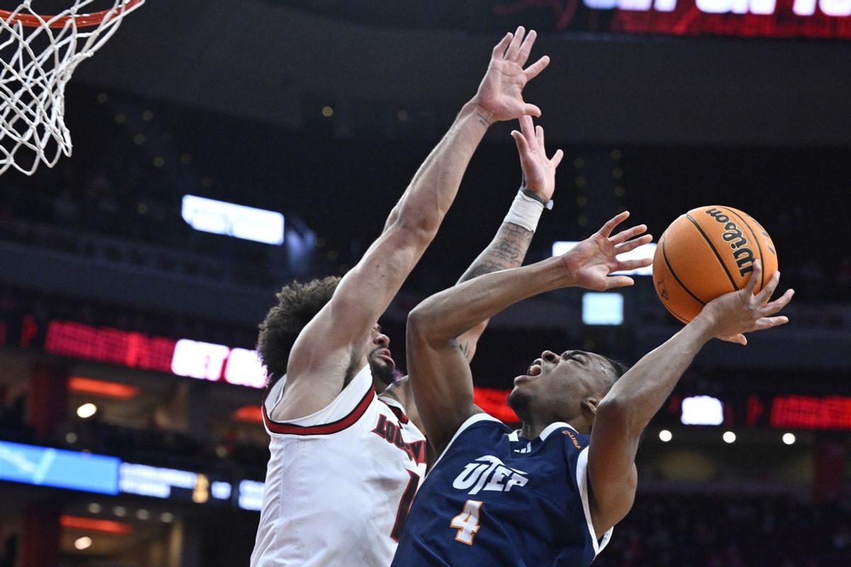 Dec 11, 2024; Louisville, Kentucky, USA;  UTEP Miners guard Corey Camper Jr. (4) shoots against Louisville Cardinals guard J'Vonne Hadley (1) during the first half at KFC Yum! Center. Mandatory Credit: Jamie Rhodes-Imagn Images