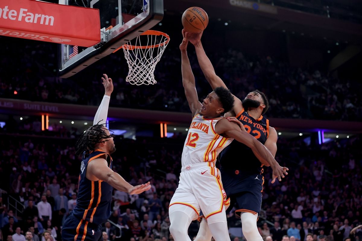 Dec 11, 2024; New York, New York, USA; New York Knicks center Karl-Anthony Towns (32) blocks a shot by Atlanta Hawks forward De'Andre Hunter (12) in front of Knicks guard Jalen Brunson (11) during the second quarter at Madison Square Garden. Mandatory Credit: Brad Penner-Imagn Images