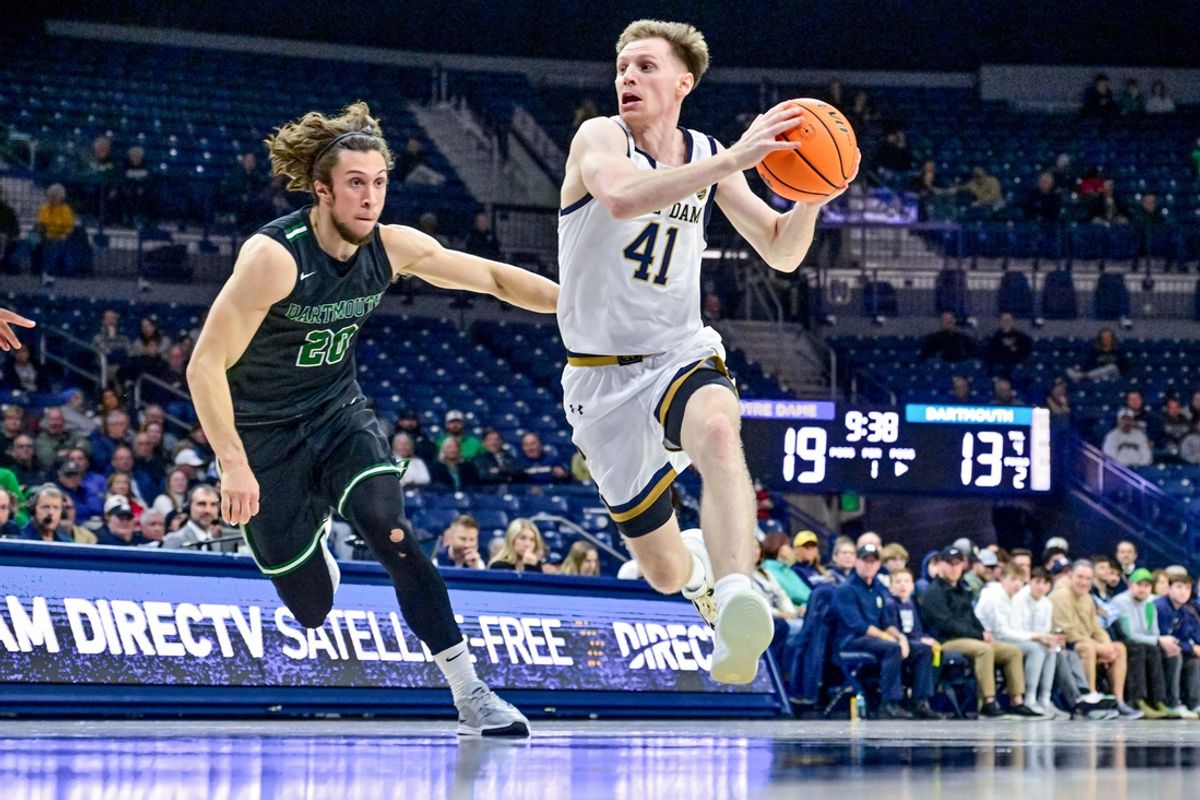 Dec 11, 2024; South Bend, Indiana, USA; Notre Dame Fighting Irish guard Matt Allocco (41) dribbles as Dartmouth Big Green guard Romeo Myrthil (20) defends in the first half at the Purcell Pavilion. Mandatory Credit: Matt Cashore-Imagn Images