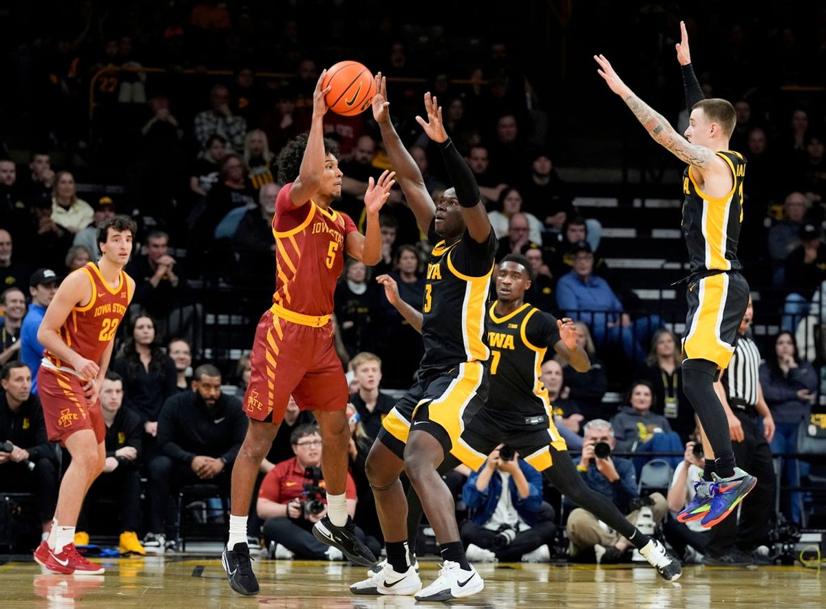 Iowa State Cyclones guard Curtis Jones (5) passes as Iowa Hawkeyes forward Ladji Dembele (13) defends Thursday, Dec. 12, 2024 at Carver-Hawkeye Arena in Iowa City, Iowa.
