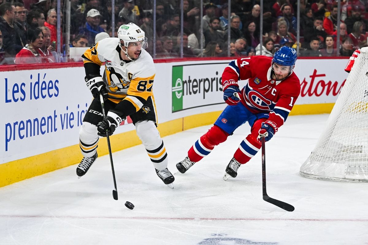 Dec 12, 2024; Montreal, Quebec, CAN; Pittsburgh Penguins center Sidney Crosby (87) plays the puck against Montreal Canadiens center Nick Suzuki (14) during the third period at Bell Centre. Mandatory Credit: David Kirouac-Imagn Images
